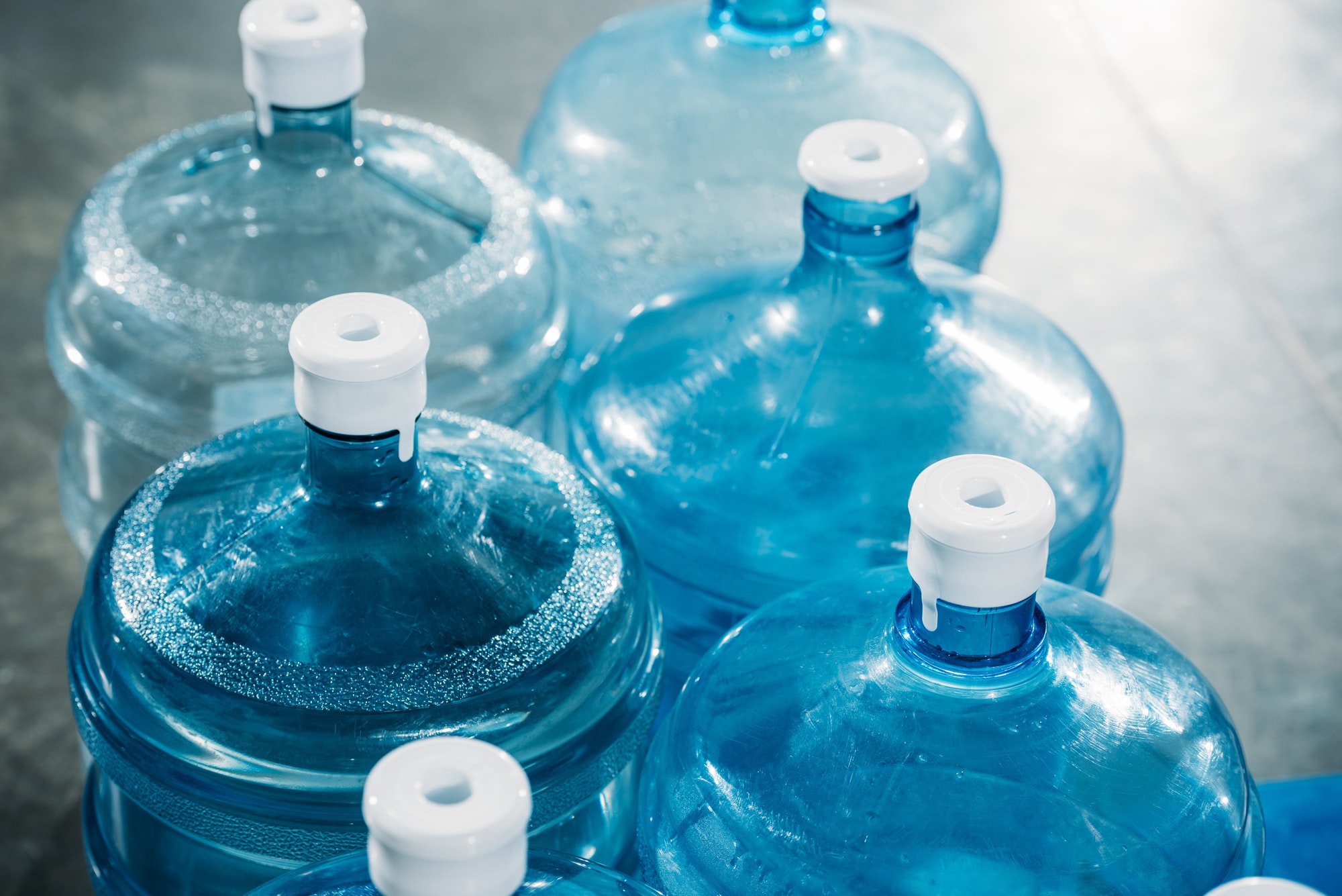 Rows of plastic blue water bottles