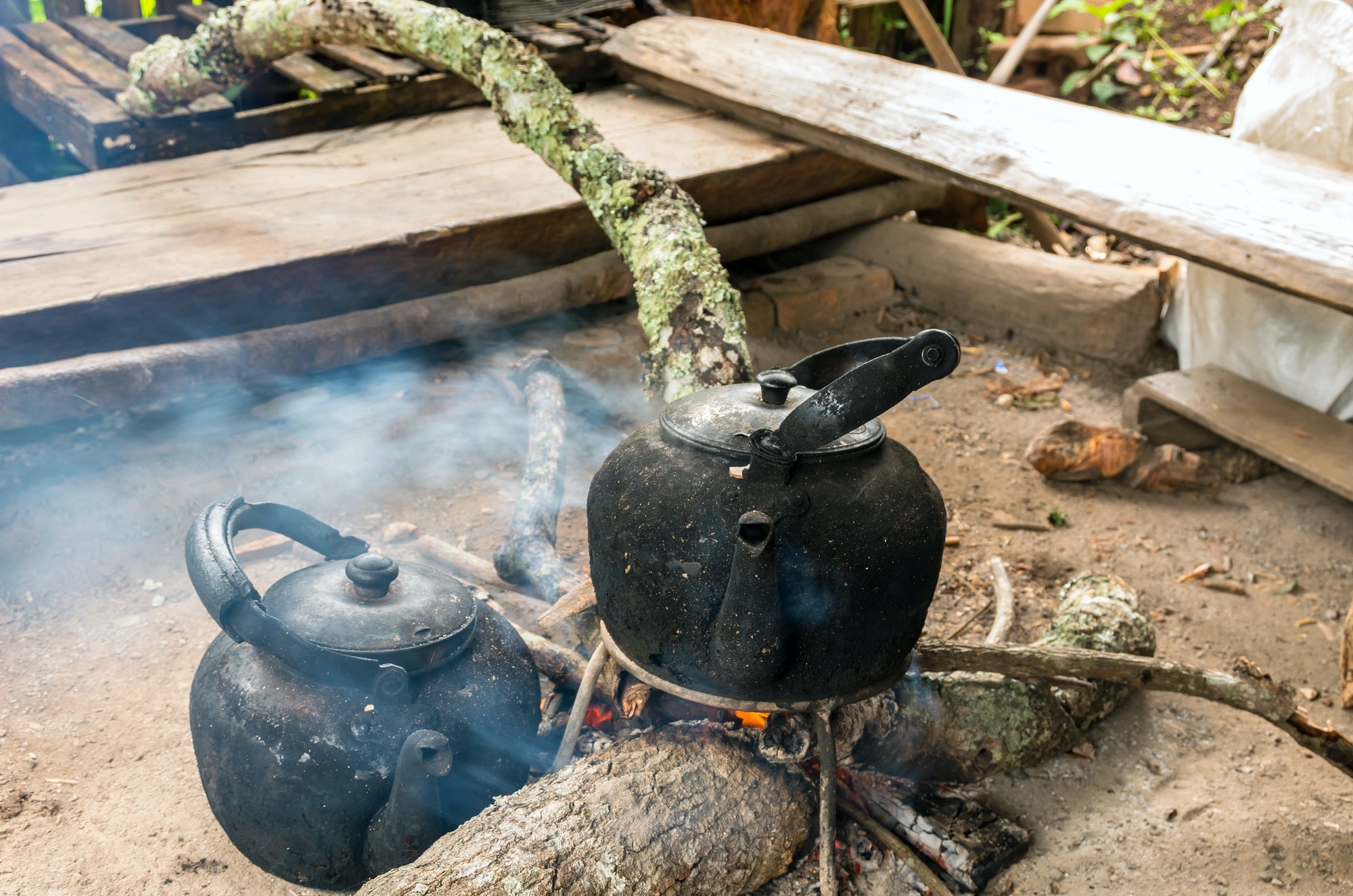 Vintage traditional kettle for boiling water on Wood sticks